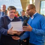 Gov. JB Pritzker and lieutenant governor candidate Christian Mitchell prepare to file nominating petitions at the Illinois State Board of Elections building in Springfield on Monday, Oct. 27. Between them is Cook County Republican Party Chair Aaron Del Mar, who is running for lieutenant governor on the GOP ticket alongside former state Sen. Darren Bailey. (Capitol News Illinois photo by Jerry Nowicki) Gov. JB Pritzker and lieutenant governor candidate Christian Mitchell prepare to file nominating petitions at the Illinois State Board of Elections building in Springfield on Monday, Oct. 27. Between them is Cook County Republican Party Chair Aaron Del Mar, who is running for lieutenant governor on the GOP ticket alongside former state Sen. Darren Bailey. (Capitol News Illinois photo by Jerry Nowicki)
