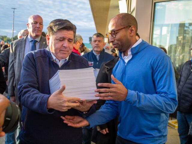 Gov. JB Pritzker and lieutenant governor candidate Christian Mitchell prepare to file nominating petitions at the Illinois State Board of Elections building in Springfield on Monday, Oct. 27. Between them is Cook County Republican Party Chair Aaron Del Mar, who is running for lieutenant governor on the GOP ticket alongside former state Sen. Darren Bailey. (Capitol News Illinois photo by Jerry Nowicki) Gov. JB Pritzker and lieutenant governor candidate Christian Mitchell prepare to file nominating petitions at the Illinois State Board of Elections building in Springfield on Monday, Oct. 27. Between them is Cook County Republican Party Chair Aaron Del Mar, who is running for lieutenant governor on the GOP ticket alongside former state Sen. Darren Bailey. (Capitol News Illinois photo by Jerry Nowicki)