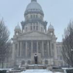 Snow falls on the Illinois Capitol Saturday, November 29.