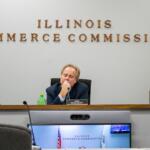 llinois Commerce Commission Chair Dough Scott is pictured alongside commissioners Michael Carrigan (left) and Ann McCabe (right) at a November 2023 meeting in Springfield. (Capitol News Illinois photo by Jerry Nowicki)