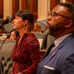 Reps. Eva-Dina Delgado and Kam Buckner watch the House of Representatives discuss their proposal to reform Chicagoland public transit. The two Chicago Democrats led a House working group tasked with overseeing negotiations. (Capitol News Illinois photo by Andrew Adams)