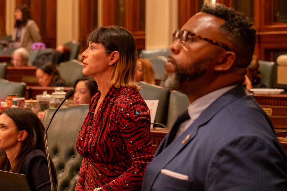 Reps. Eva-Dina Delgado and Kam Buckner watch the House of Representatives discuss their proposal to reform Chicagoland public transit. The two Chicago Democrats led a House working group tasked with overseeing negotiations. (Capitol News Illinois photo by Andrew Adams)