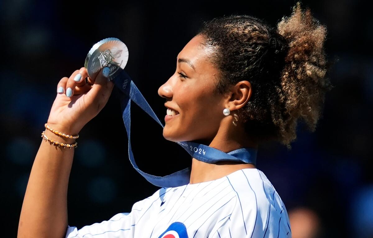 FILE - U.S. Olympic wrestler Kennedy Blades shows her silver medal from the Paris Olympic Games before a baseball game between the Oakland Athletics and the Chicago Cubs in Chicago on Sept. 18, 2024. (AP Photo/Nam Y. Huh, File)