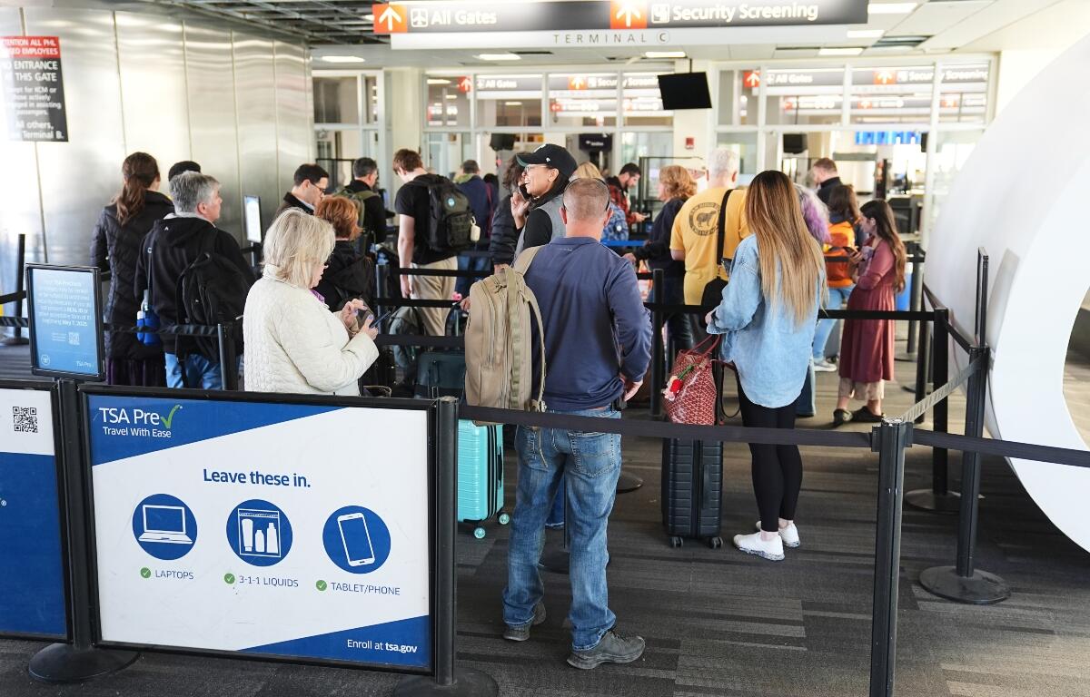 Travelers stand in line in a TSA screening area at Philadelphia International Airport in Philadelphia, Wednesday, Nov. 5, 2025. (AP Photo/Matt Rourke)