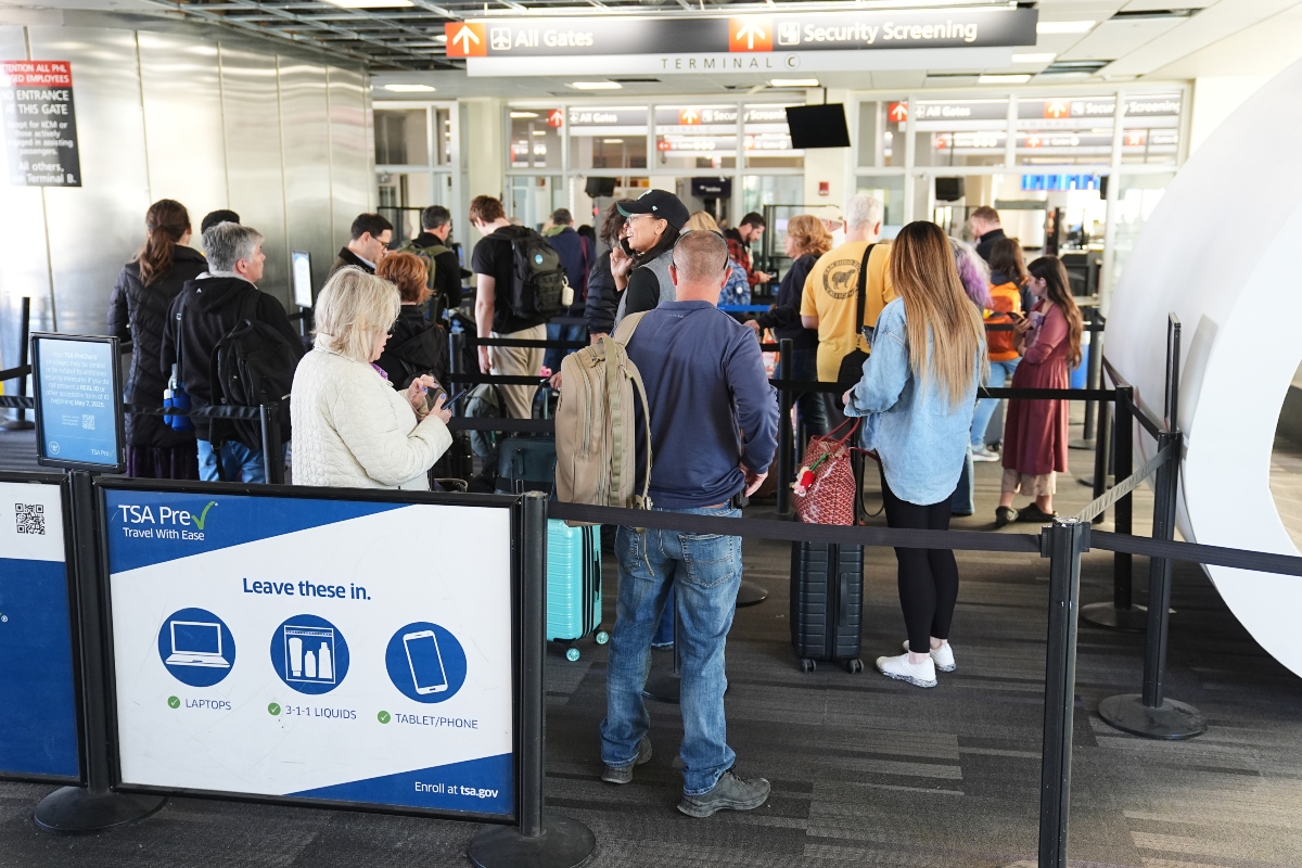 Travelers stand in line in a TSA screening area at Philadelphia International Airport in Philadelphia, Wednesday, Nov. 5, 2025. (AP Photo/Matt Rourke)