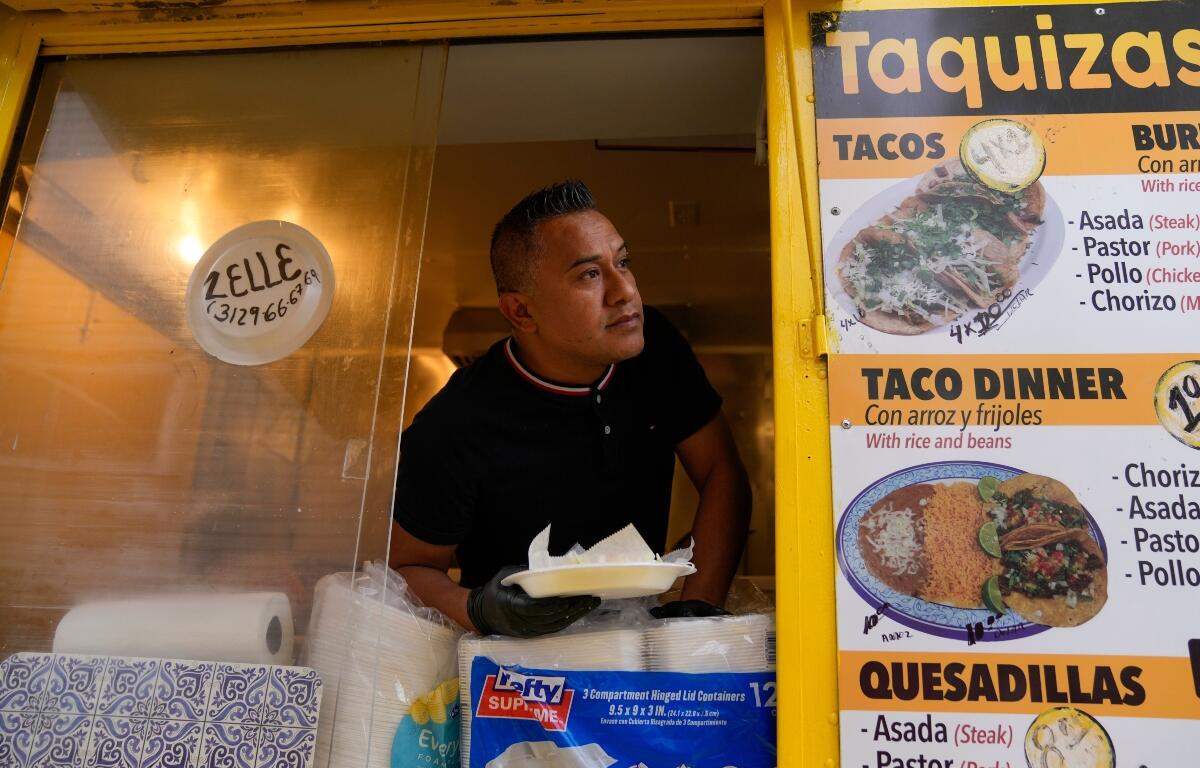 Rafael Hernandez, originally from Mexico, sells food from his family's food truck, Nov. 6, 2025, in Chicago. (AP Photo/Erin Hooley)