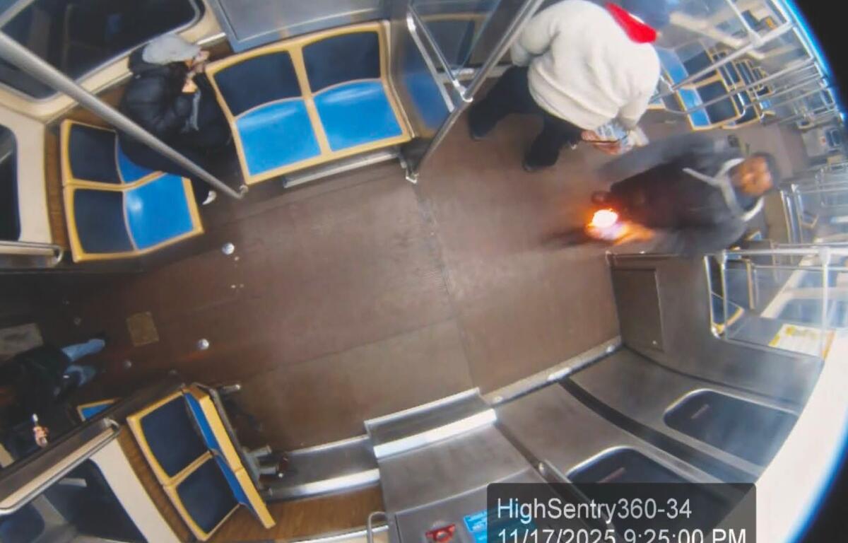 This still image taken from Chicago Transit Authority surveillance footage and included in a federal court record shows a man who federal authorities identified as Lawrence Reed holding a flaming bottle and approaching a passenger, far left, on Monday, Nov. 17, 2025, on a Chicago Blue Line train. (Chicago Transit Authority/U.S. District Court Northern District of Illinois via AP) Screenshot