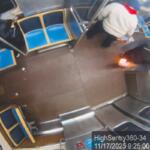 This still image taken from Chicago Transit Authority surveillance footage and included in a federal court record shows a man who federal authorities identified as Lawrence Reed holding a flaming bottle and approaching a passenger, far left, on Monday, Nov. 17, 2025, on a Chicago Blue Line train. (Chicago Transit Authority/U.S. District Court Northern District of Illinois via AP) Screenshot