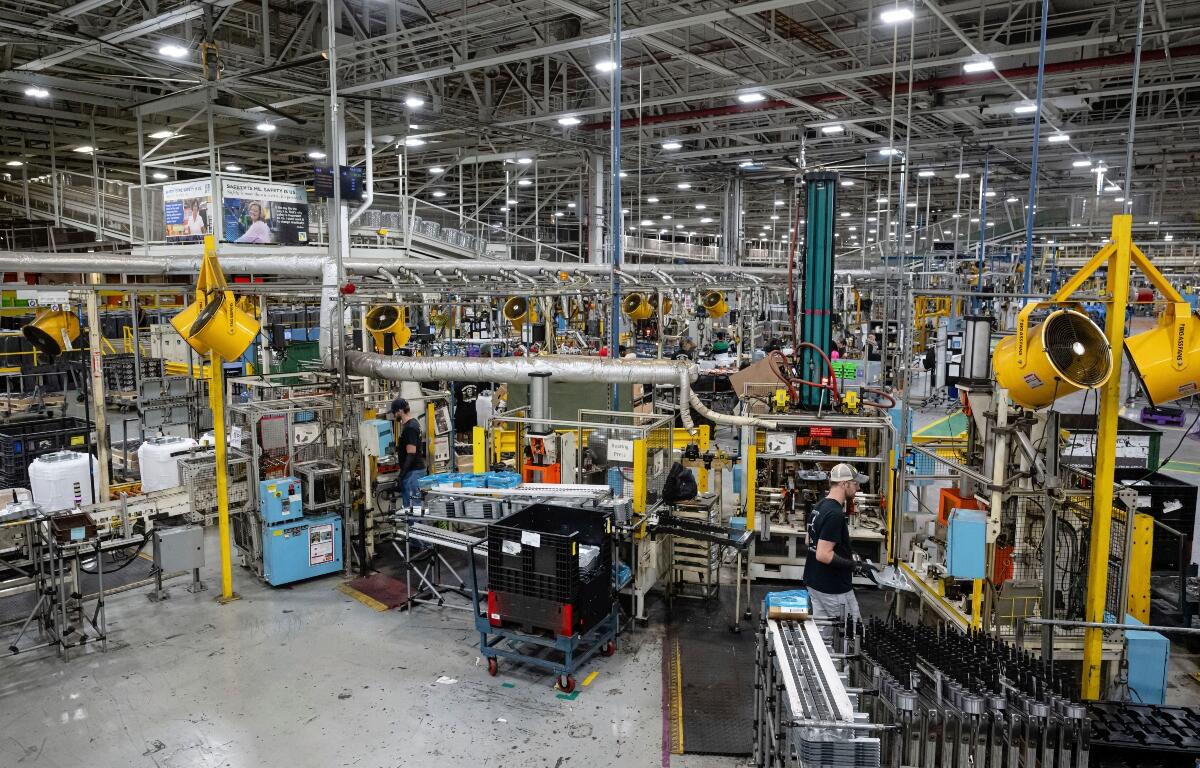 FILE - Employees piece together components on an assembly line at GE Appliances global headquarters, Aug 13, 2025, in Louisville, Ky. (AP Photo/Jon Cherry, file)