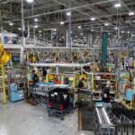 FILE - Employees piece together components on an assembly line at GE Appliances global headquarters, Aug 13, 2025, in Louisville, Ky. (AP Photo/Jon Cherry, file)