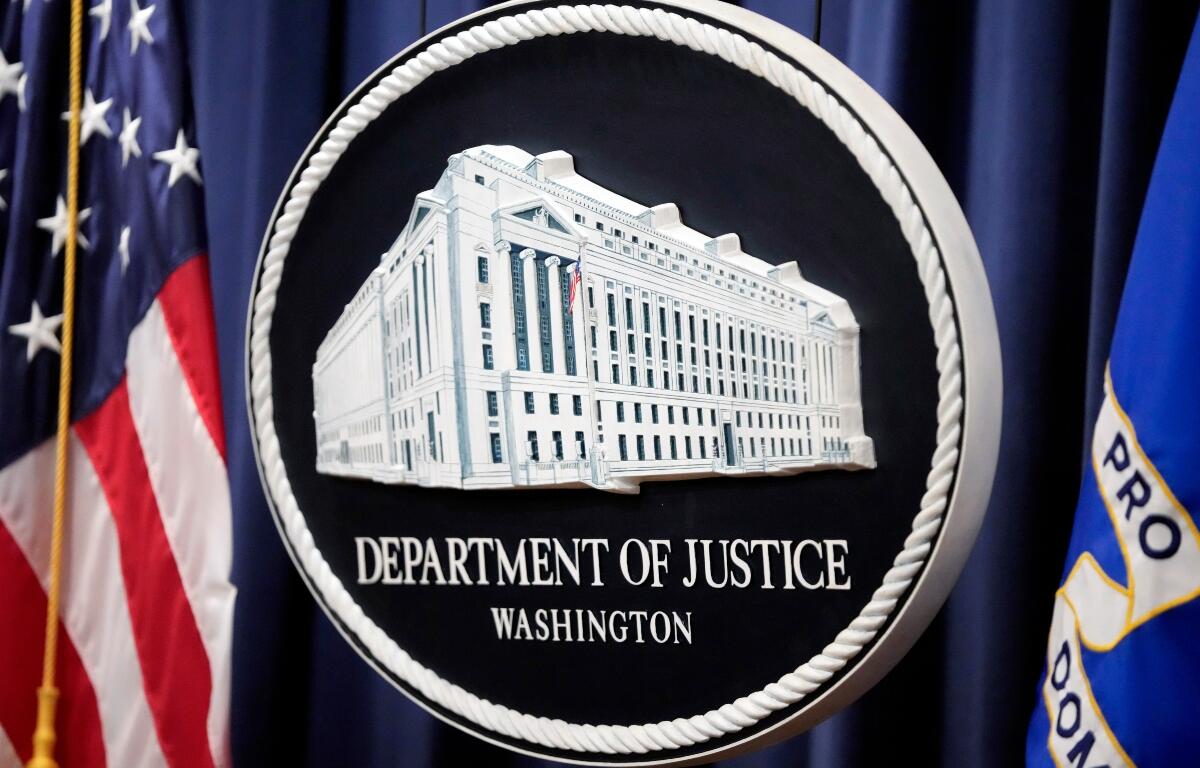 FILE - The logo for the Justice Department is seen before a news conference at the Department of Justice on Aug. 23, 2024, in Washington. (AP Photo/Mark Schiefelbein, File)