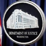 FILE - The logo for the Justice Department is seen before a news conference at the Department of Justice on Aug. 23, 2024, in Washington. (AP Photo/Mark Schiefelbein, File)