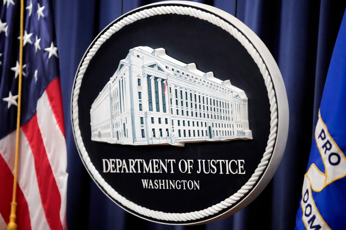 FILE - The logo for the Justice Department is seen before a news conference at the Department of Justice on Aug. 23, 2024, in Washington. (AP Photo/Mark Schiefelbein, File)