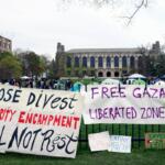FILE - Signs are displayed outside a tent encampment at Northwestern University on April 26, 2024, in Evanston, Illinois. (AP Photo/Teresa Crawford, file)