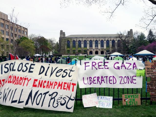 FILE - Signs are displayed outside a tent encampment at Northwestern University on April 26, 2024, in Evanston, Illinois. (AP Photo/Teresa Crawford, file)