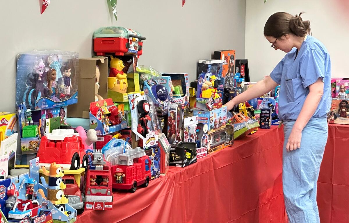 Melanie Barnard "shops" for presents in "Santa's Workshop" at HSHS St. John's Children's Hospital. Barnard's son Stuart is recovering there after recent surgery.