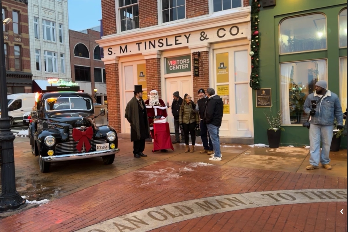 Santa, Abraham Lincoln, and others prepare for a tree lighting ceremony last week at the Old State Capitol Plaza downtown.