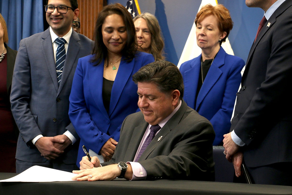 Gov. JB Pritzker signs House Bill 767 at a Dec. 2 news conference in Chicago. He said the bill will protect Illinoisians using science-backed guidelines, rather than “junk science” used by the federal administration under the guidance of Health and Human Services Secretary Robert F. Kennedy Jr. (CNI photo by Maggie Dougherty)