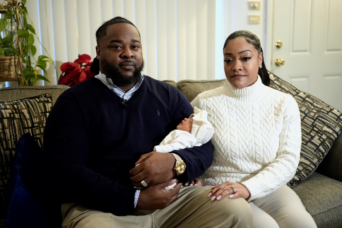 Leon and Mercedes Wells hold their newborn daughter Alena at their home in the Chicago suburb of Dolton, Ill. on Friday, Nov. 28, 2025. (AP Photo/Mark Vancleave)