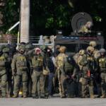 FILE - Greg Bovino, the chief patrol agent for the U.S. Border Patrol El Centro sector, center, stands with federal immigration agents near an Immigration and Customs Enforcement facility in Broadview, Ill., Oct. 3, 2025. (AP Photo/Erin Hooley, File)