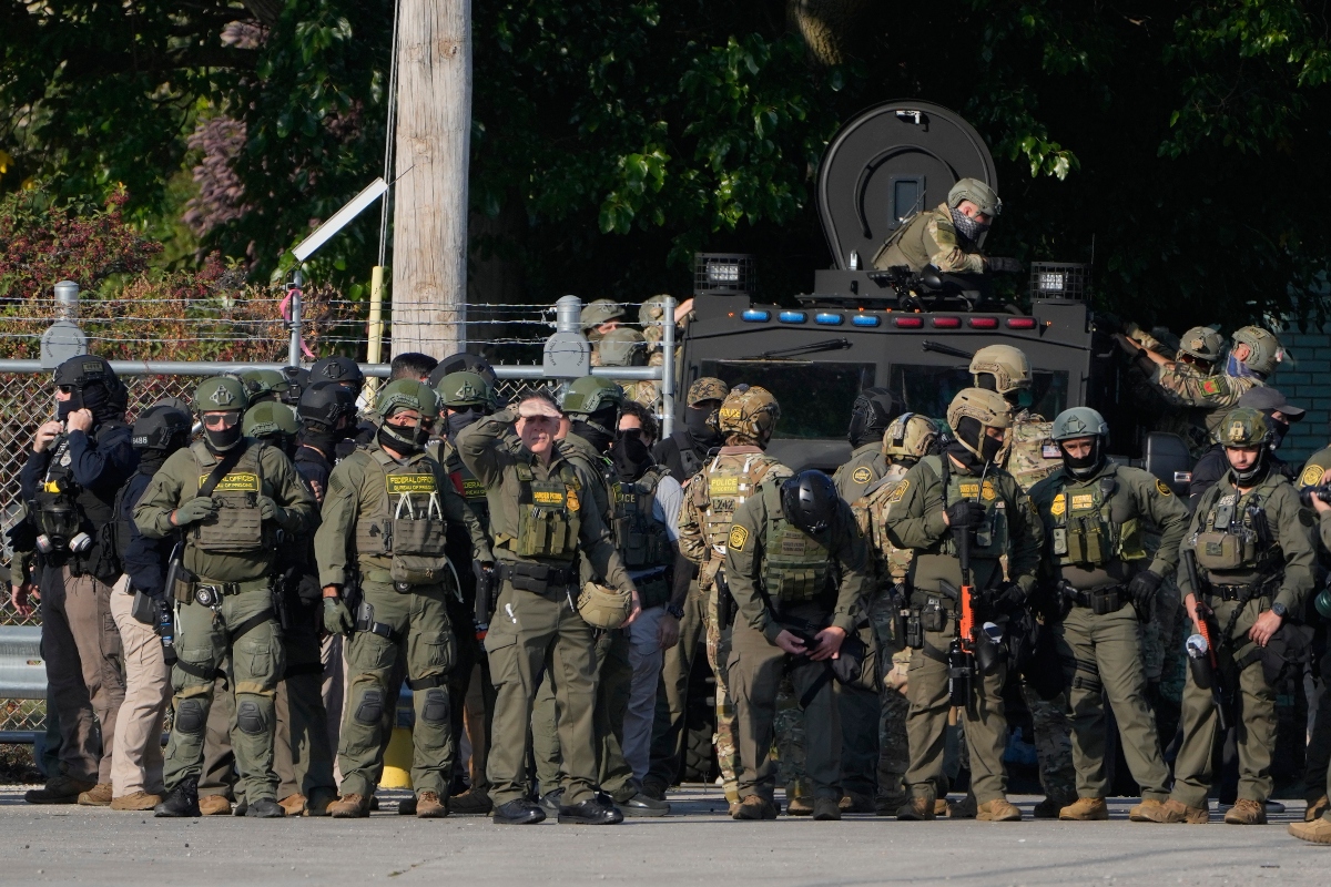 FILE - Greg Bovino, the chief patrol agent for the U.S. Border Patrol El Centro sector, center, stands with federal immigration agents near an Immigration and Customs Enforcement facility in Broadview, Ill., Oct. 3, 2025. (AP Photo/Erin Hooley, File)