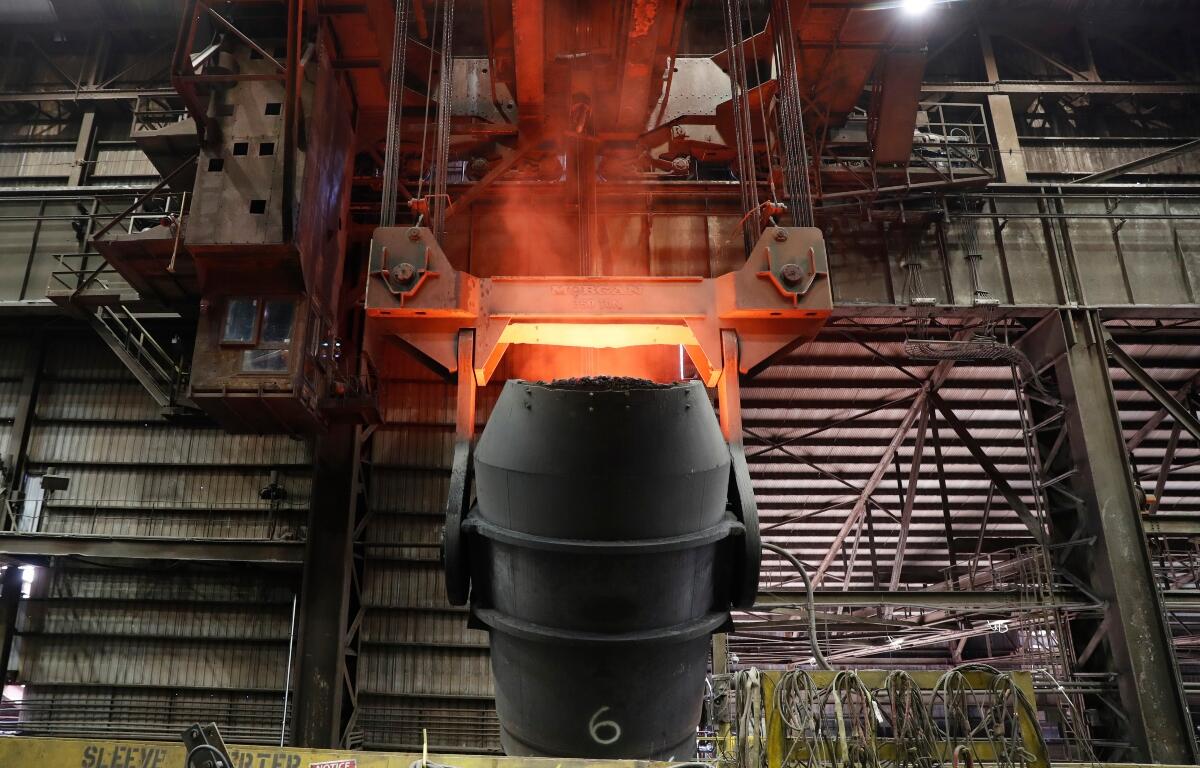 FILE - A giant ladle glows red after pouring molten iron in to a vessel inside the basic oxygen furnace as part of the processes of making steel at the U.S. Steel Granite City Works facility Thursday, June 28, 2018, in Granite City, Ill. (AP Photo/Jeff Roberson, File)