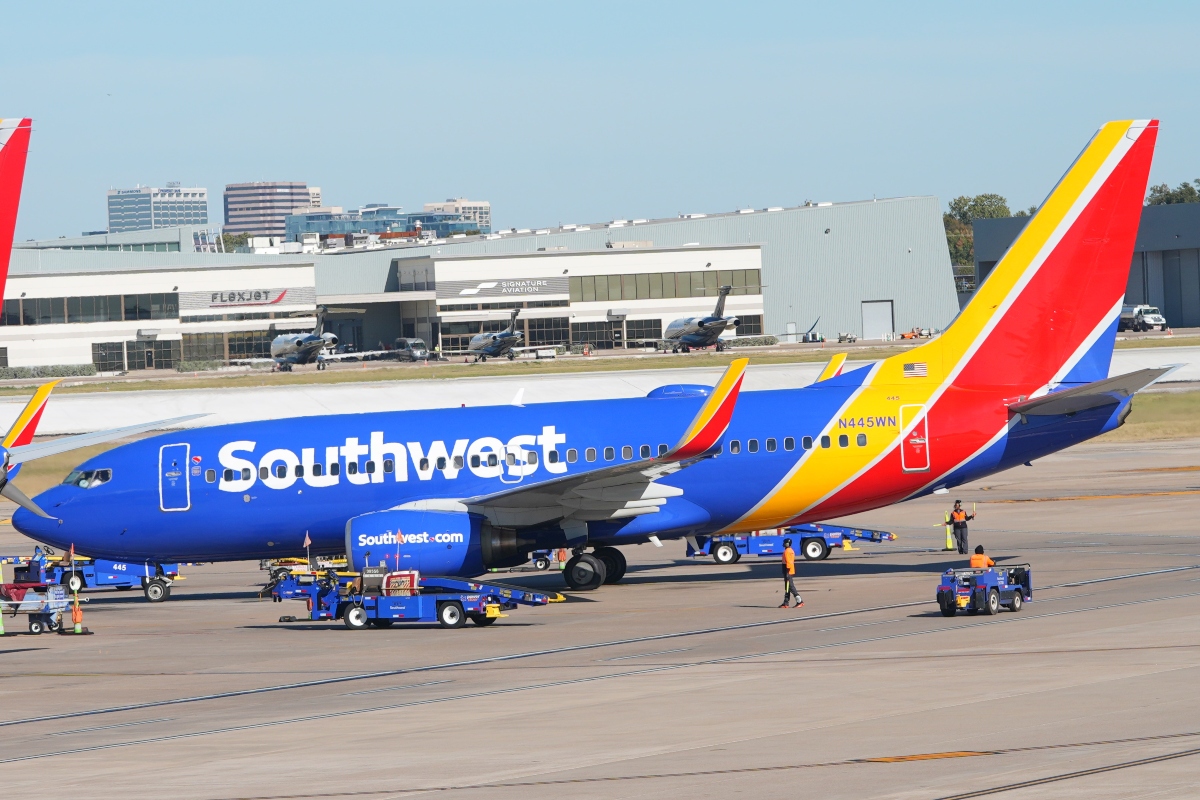 FILE - A Southwest Airlines jet pulls into a gate at Dallas Love Field Airport Tuesday, Nov. 11, 2025, in Dallas. (AP Photo/LM Otero, File)