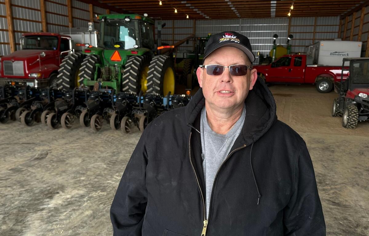 Charlie Radman, a corn and soybean farmer, stands for a photo on the land his family has owned since 1899, near Randolph, Minn., Wednesday, Dec. 10, 2025. (AP Photo/Mark Vancleave)
