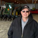 Charlie Radman, a corn and soybean farmer, stands for a photo on the land his family has owned since 1899, near Randolph, Minn., Wednesday, Dec. 10, 2025. (AP Photo/Mark Vancleave)