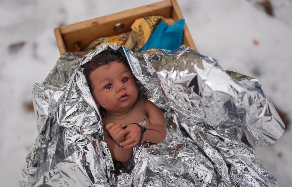 A doll representing the baby Jesus is zip-tied in the Nativity scene outside of Lake Street Church of Evanston, Wednesday, Dec. 10, 2025, in Evanston, Ill. (AP Photo/Erin Hooley)
