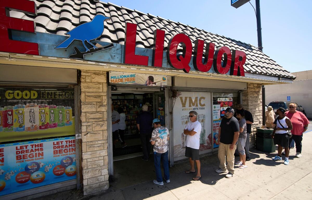 FILE - People wait in line to purchase lottery tickets outside Bluebird Liquor store in Hawthorne, Calif., on Friday, Sept. 5, 2025. (AP Photo/Damian Dovarganes, File)