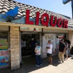 FILE - People wait in line to purchase lottery tickets outside Bluebird Liquor store in Hawthorne, Calif., on Friday, Sept. 5, 2025. (AP Photo/Damian Dovarganes, File)