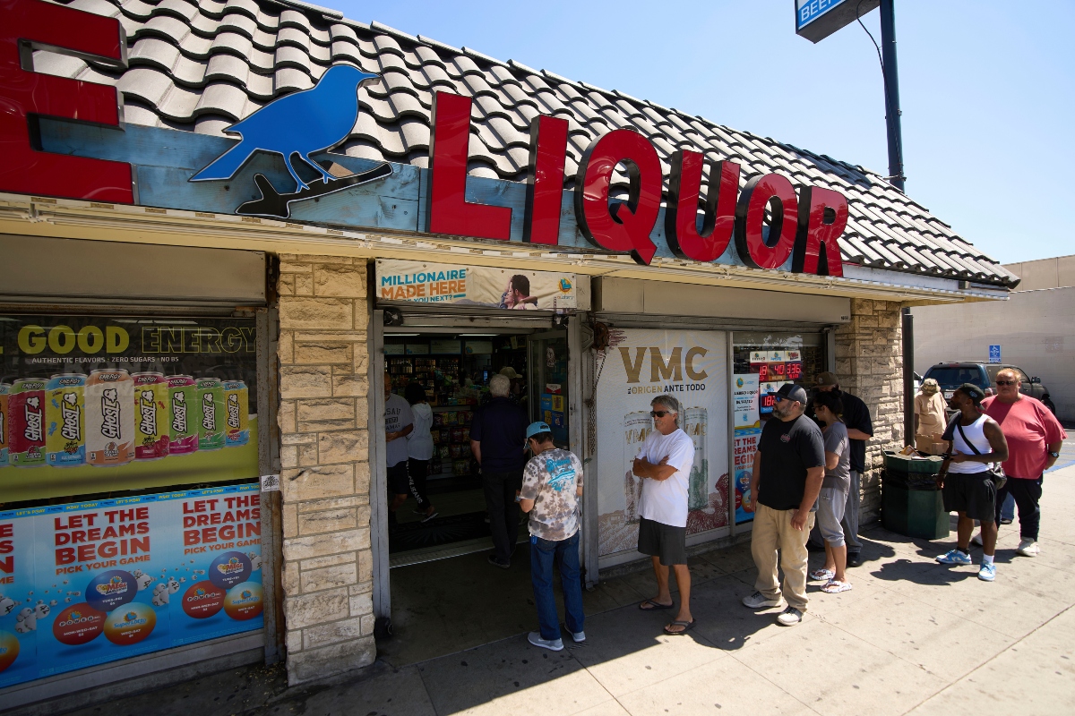 FILE - People wait in line to purchase lottery tickets outside Bluebird Liquor store in Hawthorne, Calif., on Friday, Sept. 5, 2025. (AP Photo/Damian Dovarganes, File)