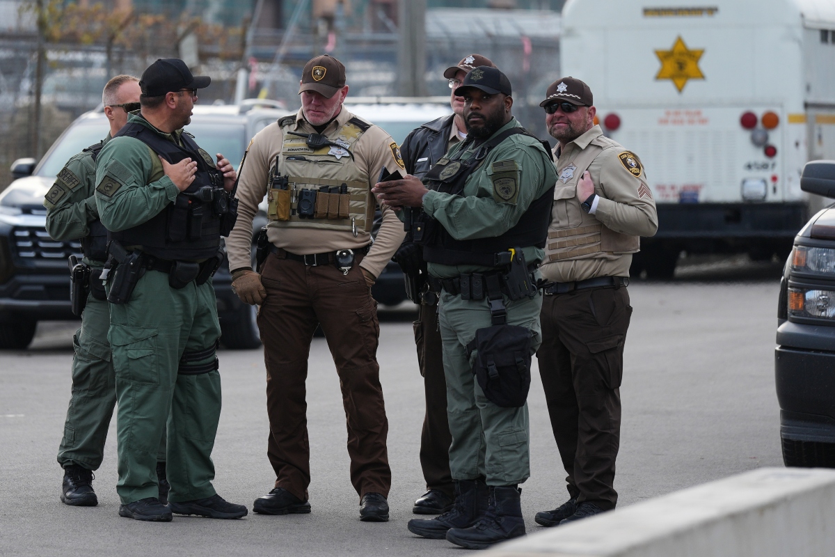 FILE - Law enforcement officers guard outside an ICE processing facility in the Chicago suburb of Broadview, Ill., on Nov. 21, 2025. (AP Photo/Nam Y. Huh, File)