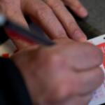 A person fills out a Powerball lottery ticket on Monday, Dec. 22, 2025, in Portland, Ore. (AP Photo/Jenny Kane)