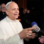 Pope Leo XIV talks to journalists as he leaves the Castel Gandolfo residence to head to the Vatican, Tuesday, Dec. 23, 2025. (AP Photo/Gregorio Borgia)