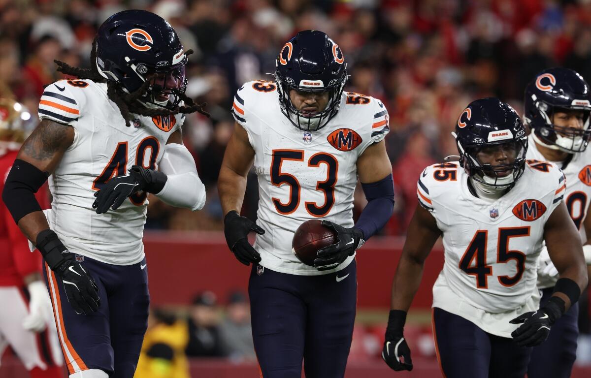 Chicago Bears linebacker T.J. Edwards (53) is congratulated by teammates after returning an interception for a touchdown during the first half of an NFL football game against the San Francisco 49ers in Santa Clara, Calif., Sunday, Dec. 28, 2025. (AP Photo/Jed Jacobsohn)