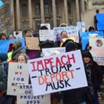 Protesters hold up signs at a rally outside the Illinois Capitol in January 2025 protesting federal government cuts pushed by President Donald Trump and Elon Musk. (Capitol News Illinois photo by Jade Aubrey)