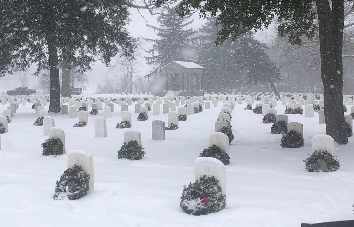 Several hundred wreaths were laid at the gravestones of veterans at Camp Butler National Cemetery Saturday as part of "Wreaths Across America."