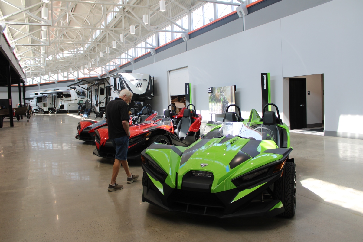 A shopper checks out a Polaris Slingshot car in the newly redeveloped mall in Marion earlier this year. (Credit: Janelle O’Dea, Illinois Answers Project)