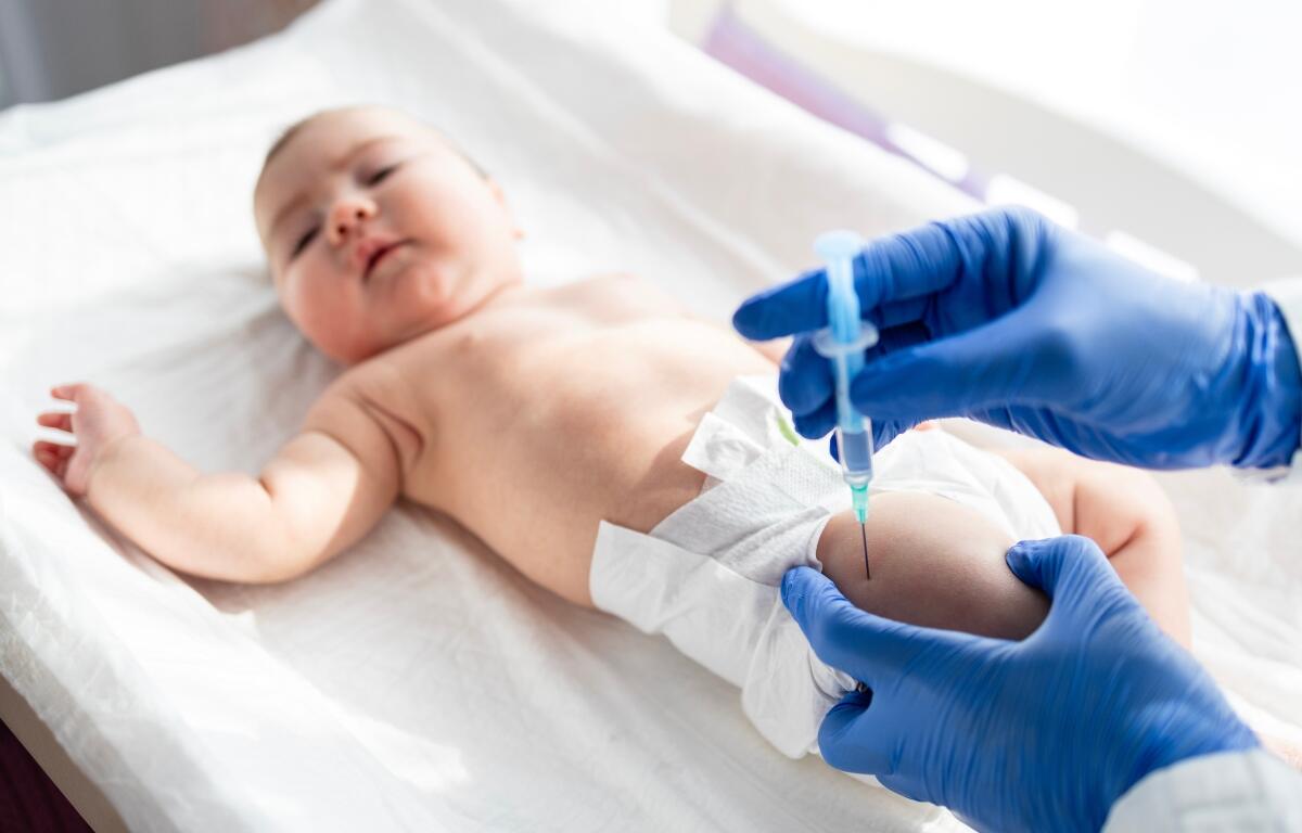 A newborn getting a vaccine.