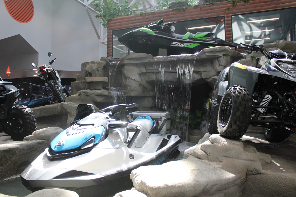 Powersport vehicles flank an indoor waterfall at the newly redeveloped Marion mall. (Credit: Janelle O’Dea, Illinois Answers Project)