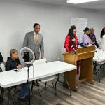 Friends, family, and supporters of Sonya Massey gather Thursday at a press conference following the sentence being read in the Sean Grayson trial. Teresa Haley, dressed in red, speaks at a podium.