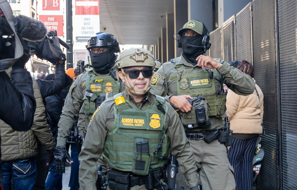 Members of the United States Border Patrol walk out of the Dirksen federal courthouse in Chicago through a sea of reporters and protesters on Oct. 28, 2025. (Capitol News Illinois photo by Andrew Adams)