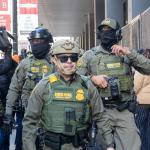 Members of the United States Border Patrol walk out of the Dirksen federal courthouse in Chicago through a sea of reporters and protesters on Oct. 28, 2025. (Capitol News Illinois photo by Andrew Adams)