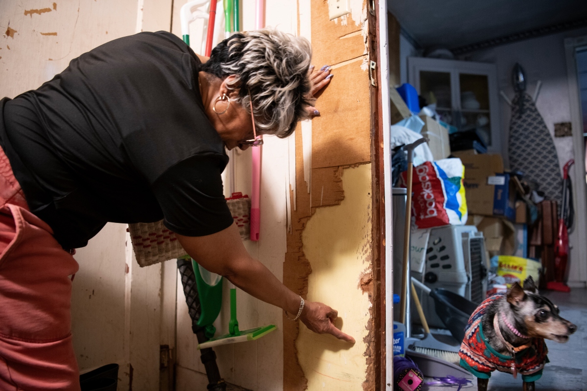Yvette Lyles points to the spot on her wall reached by floodwaters in Cahokia Heights, Ill., May 15, 2025. (AP Photo/Michael Phillis)