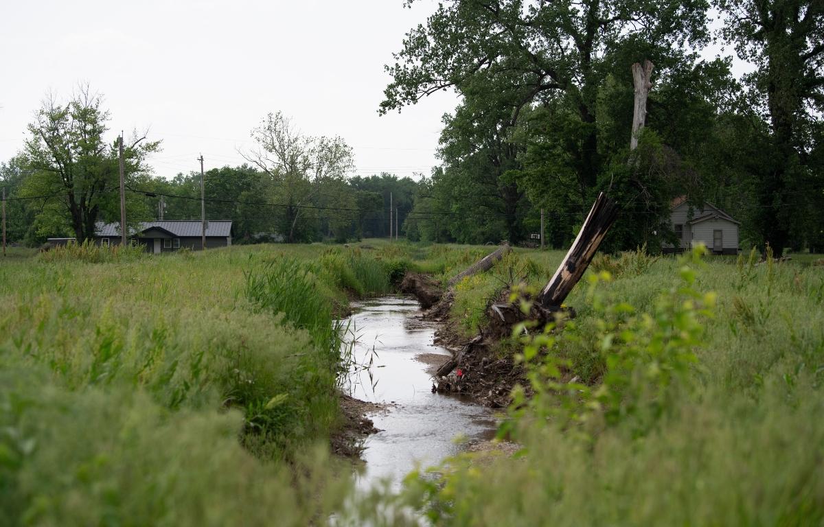 Water flows near homes in flood-prone Cahokia Heights, Ill., May 15, 2025. (AP Photo/Michael Phillis)
