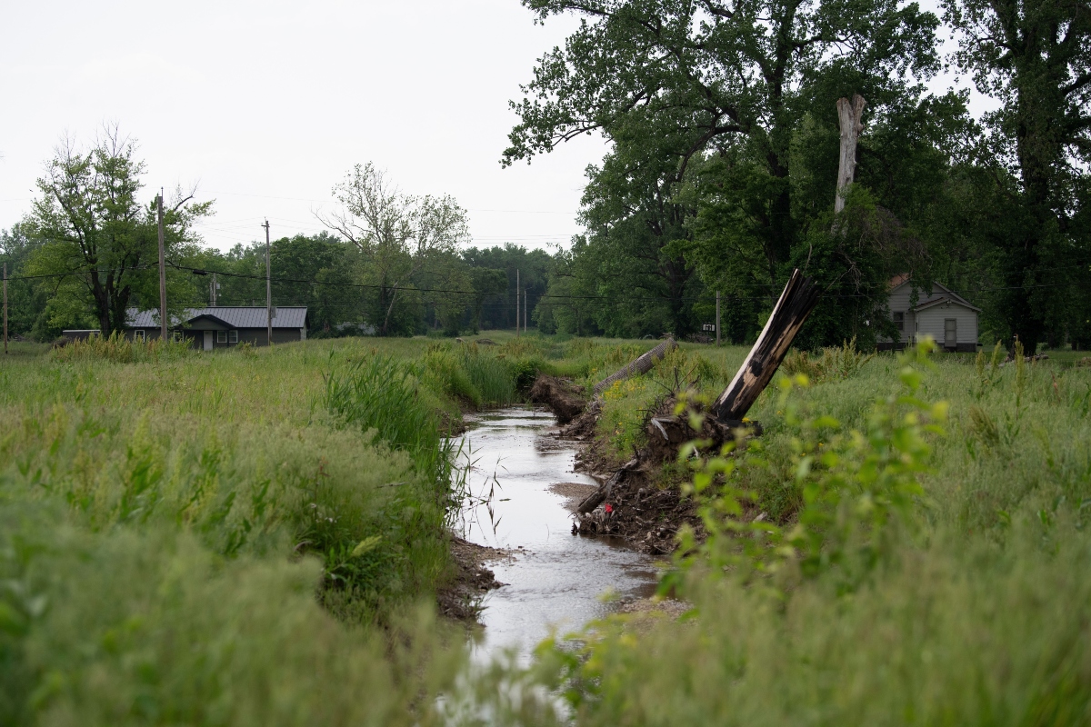 Water flows near homes in flood-prone Cahokia Heights, Ill., May 15, 2025. (AP Photo/Michael Phillis)