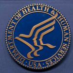FILE = The Health and Human Services seal is seen before the news conference of Secretary Robert F. Kennedy Jr. at the Hubert Humphrey Building Auditorium in Washington, Wednesday, April 16, 2025. (AP Photo/Jose Luis Magana, File)