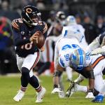 Chicago Bears quarterback Caleb Williams (18) runs from Detroit Lions linebacker al-Quadin Muhammad (96) during the second half of an NFL football game, Sunday, Jan. 4, 2026, in Chicago. (AP Photo/Nam Y. Huh)